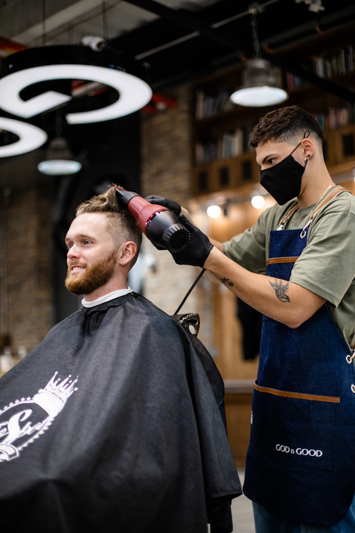 Beard being shaped and trimmed with a straight razor.